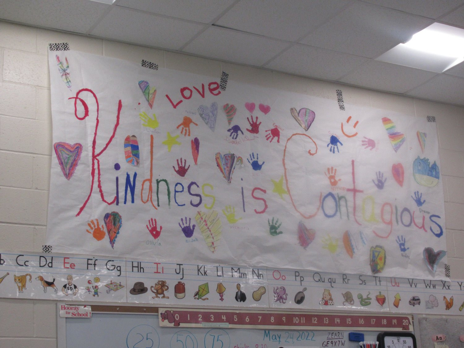 SUPER SPECIAL SLOGAN: The words “Kindness is contagious” on this huge handmade wall-hanging describe the lessons children in ECC Teacher Linda Greco’s classroom have been learning in recent months.